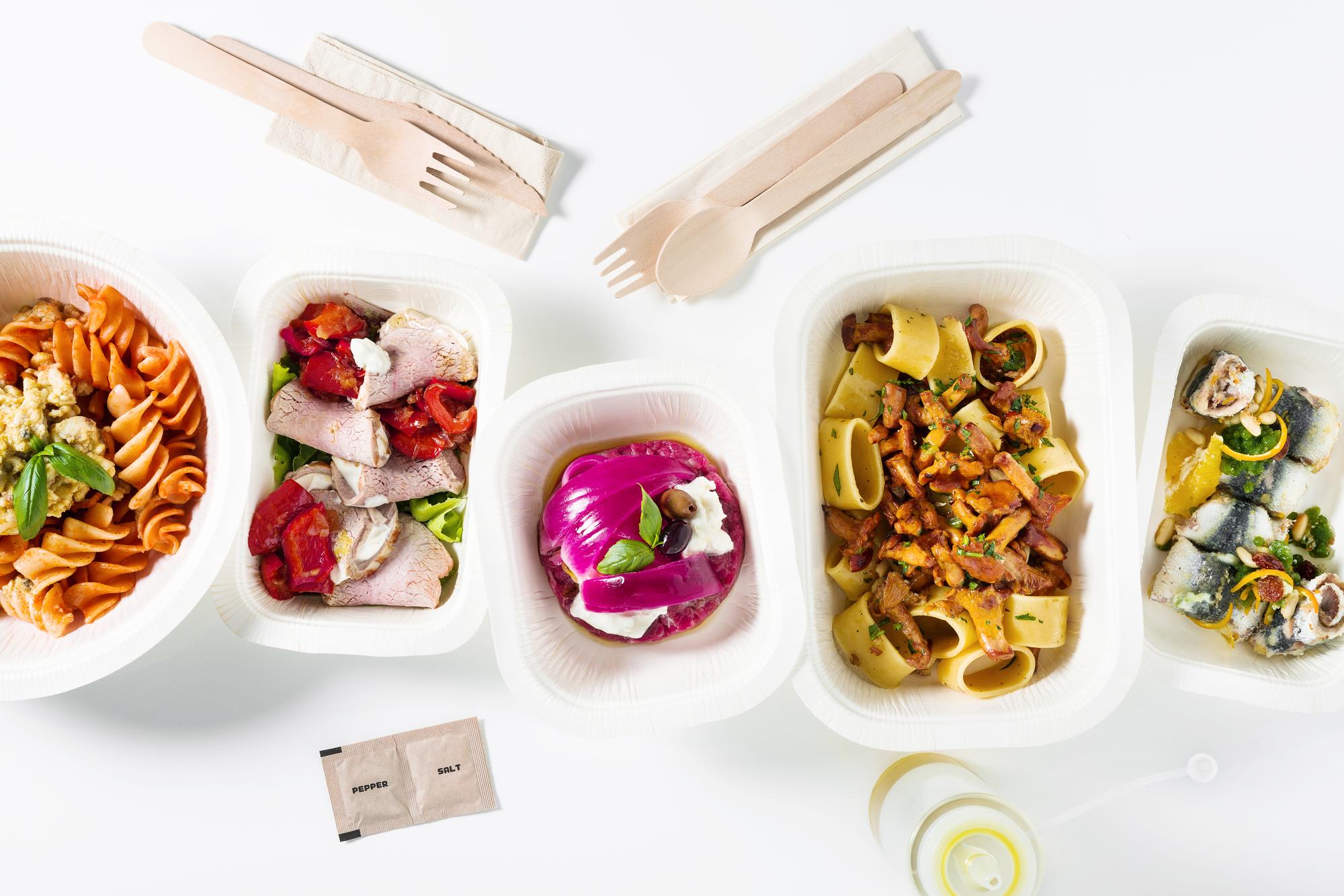 Assorted packaged meal kits stacked with labels